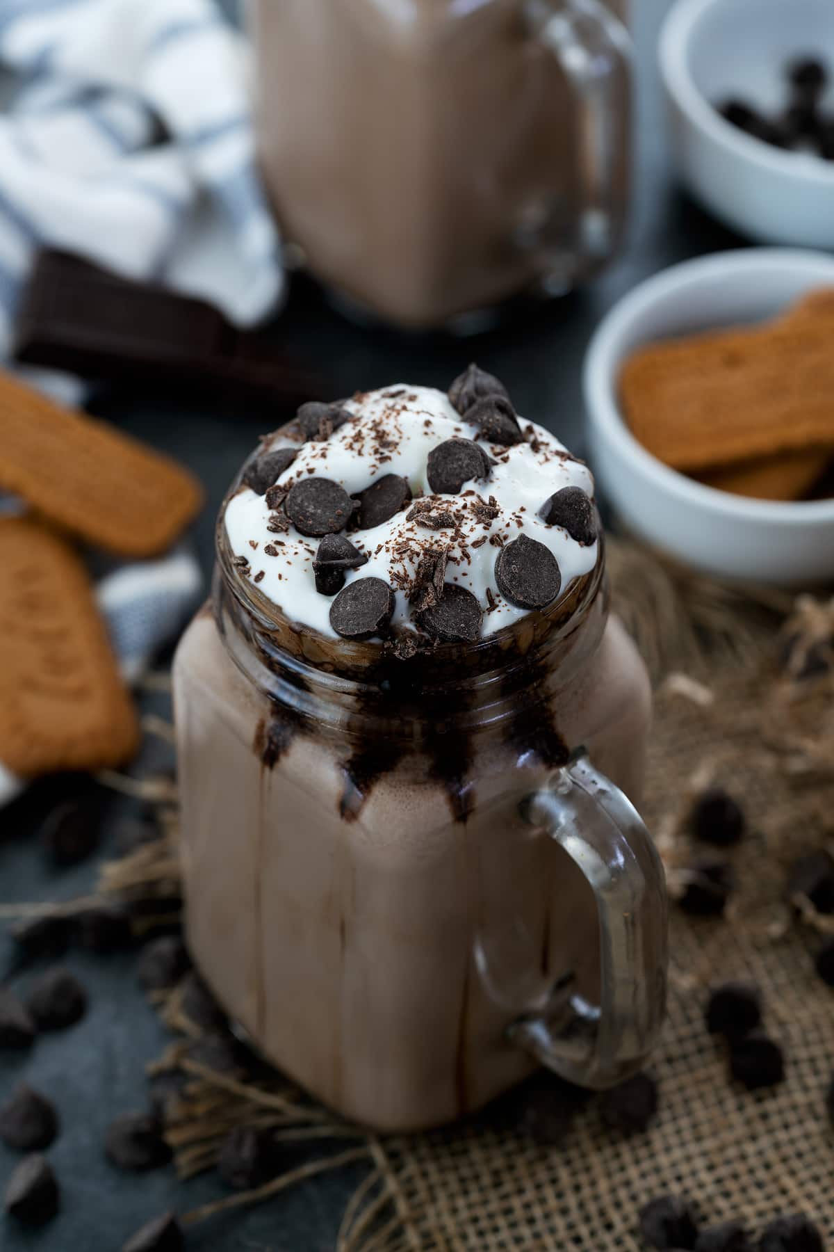 Frozen Hot Chocolate served in a jar topped with whipped cream and chocolate chip.