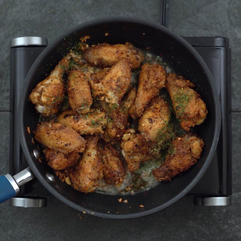 Fried garlic parmesan wings garnished with parsley