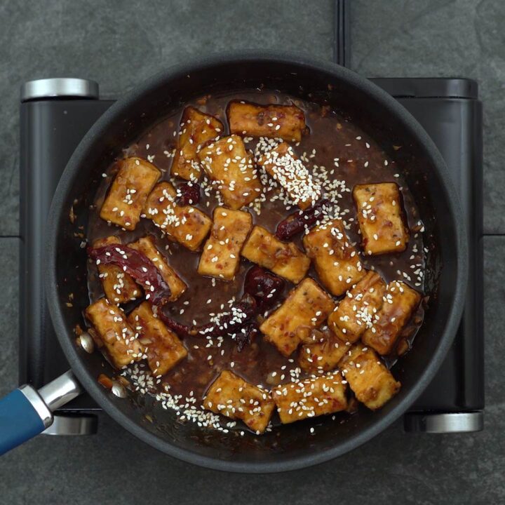 fried tofu coated in tso sauce with sesame seeds