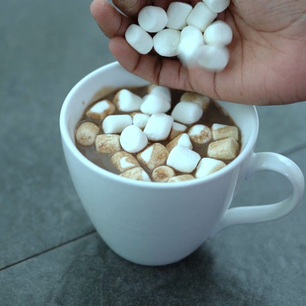 Adding marshmallow to Hot Cocoa.