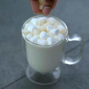 Topping the hot white chocolate.
