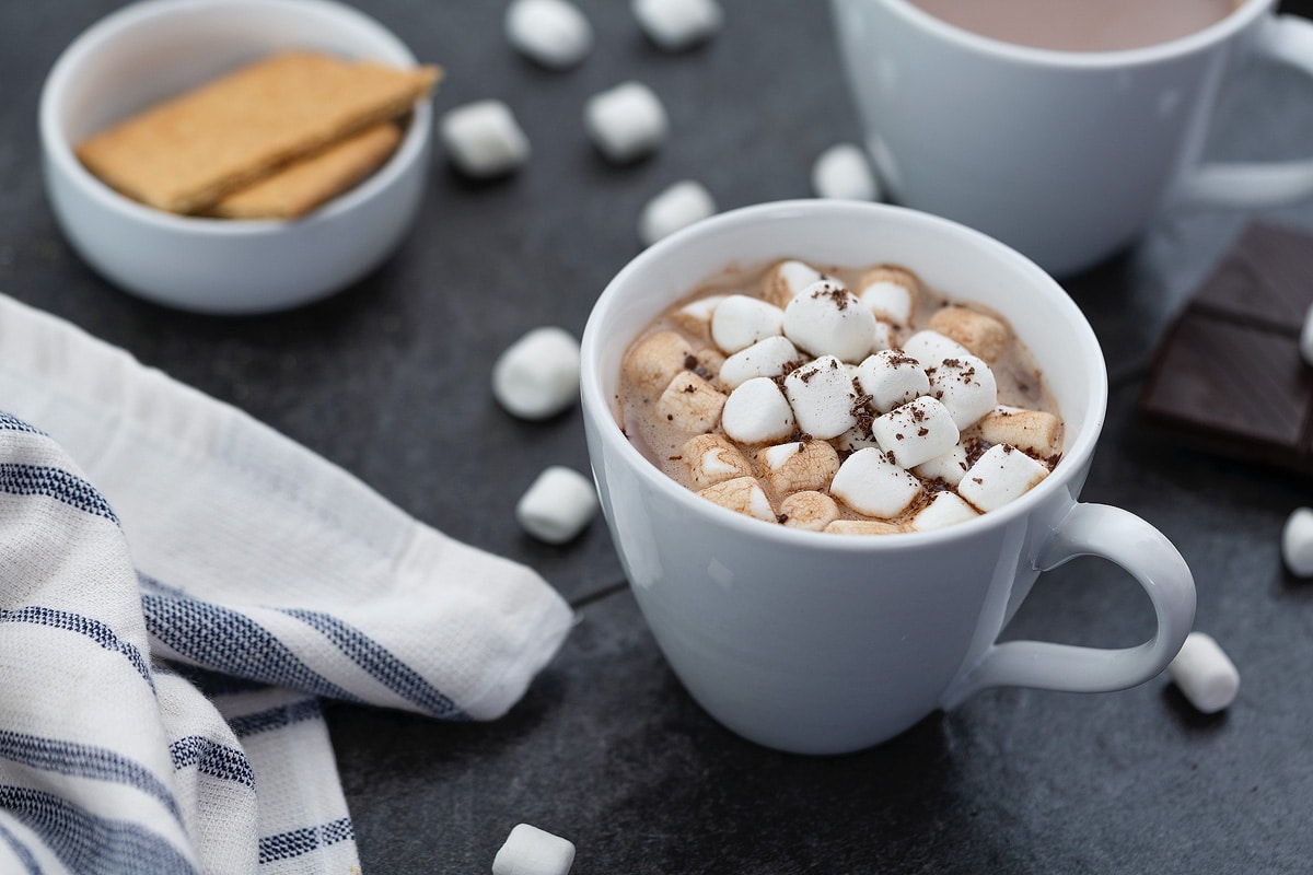 Hot Cocoa served in a cup topped with marshmallows.