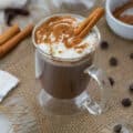 Mexican Hot Chocolate in a cup with chocolate chips around.