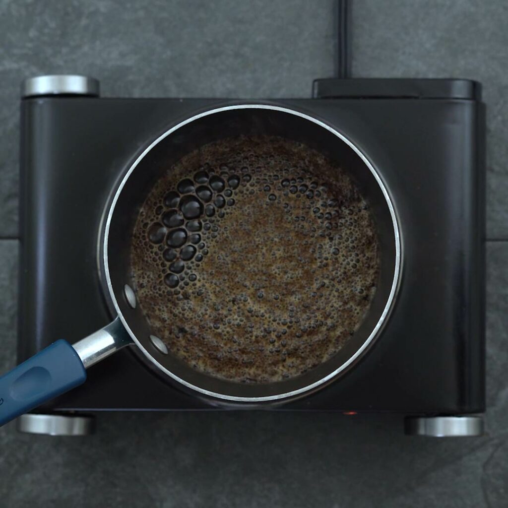 Brewing black tea in a saucepan.