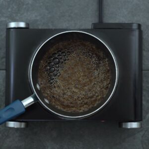 Brewing black tea in a saucepan.