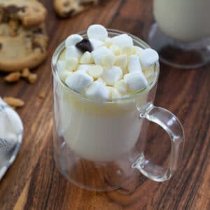 White Hot Chocolate served in a cup topped with white chocolate chip.