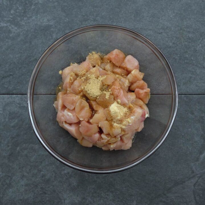 chicken breast with marination ingredients in a bowl