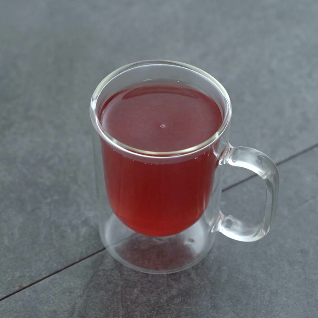 Ginger Tea served in a glass mug.