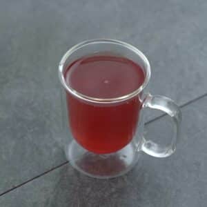 Ginger Tea served in a glass mug.