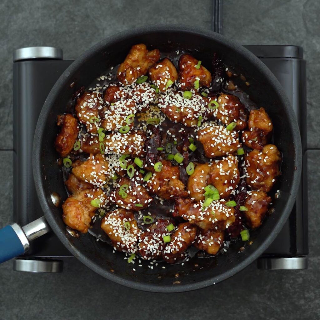 general Tso's Chicken with sesame seeds and spring onions