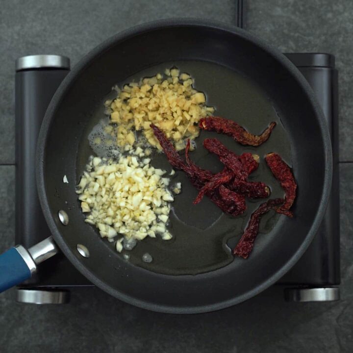 seasoning ginger, garlic and red chili in a pan