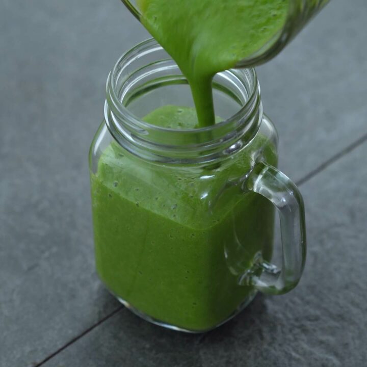 Green smoothie in a blender jar.