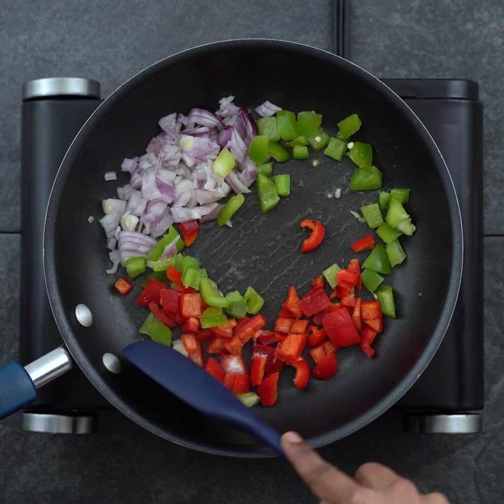 stir-frying the veggies in a pan