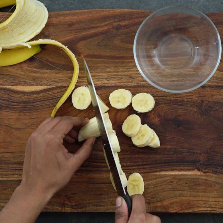 Chopping banana into small pieces.