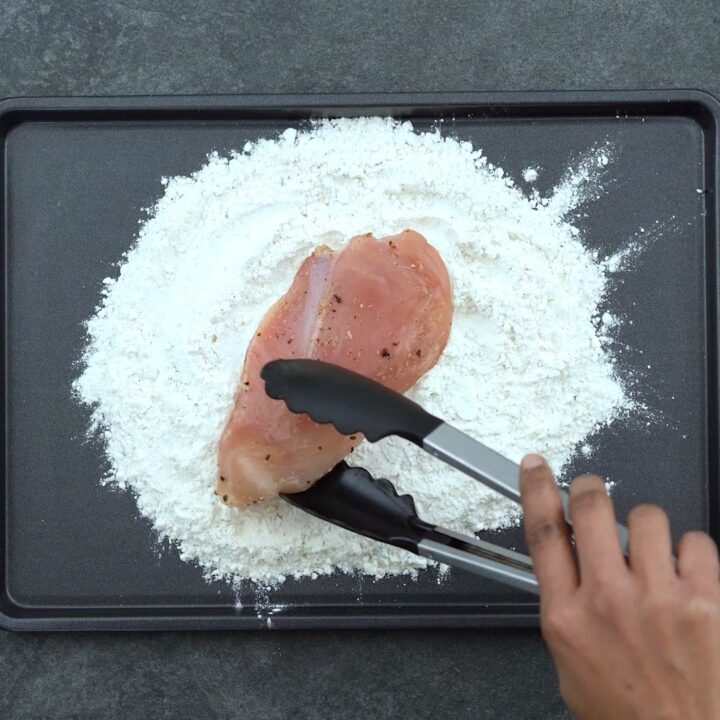 coating chicken in flour mix