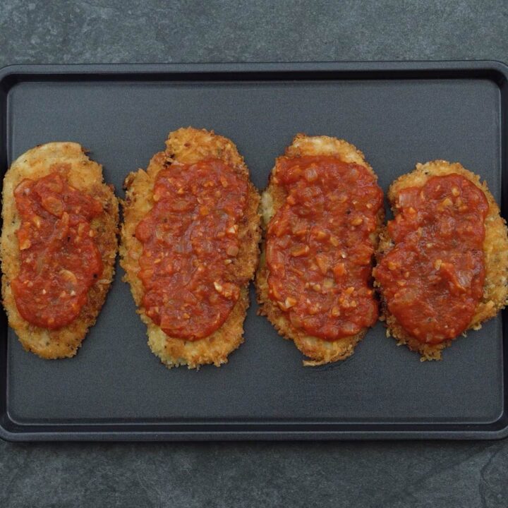 breaded chicken topped with tomato sauce