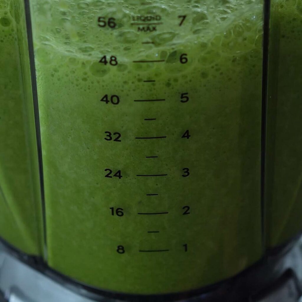 Blended green juice in blender.