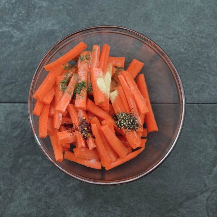 carrots with seasoning ingredients in a bowl