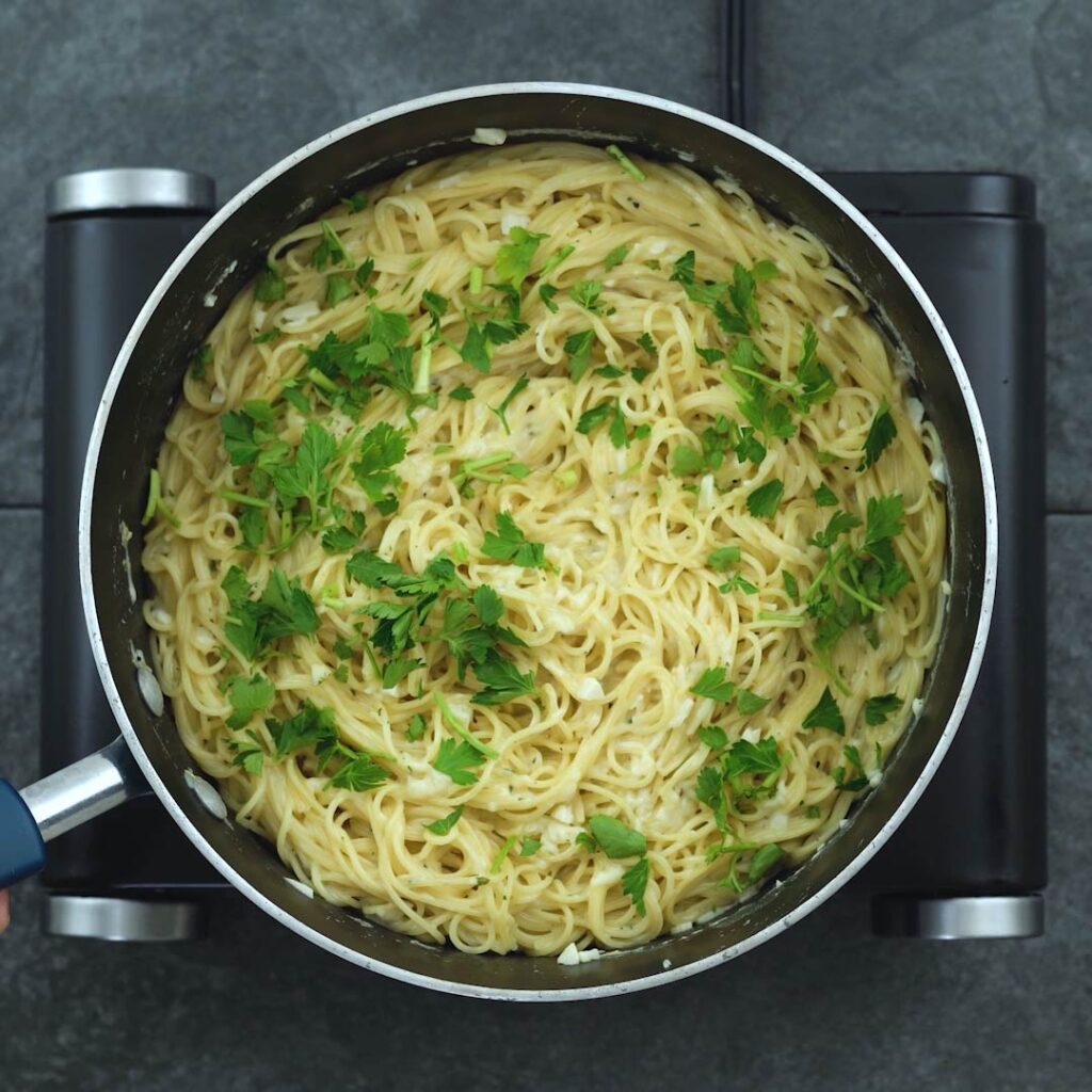 Pasta garnished with parsley leaves