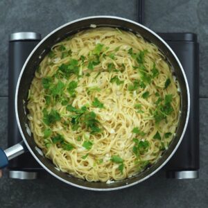 Pasta garnished with parsley leaves