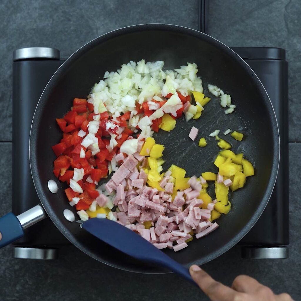 Stir- frying the veggies and ham