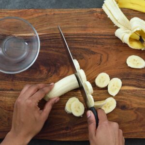 Chopping banana into small pieces.