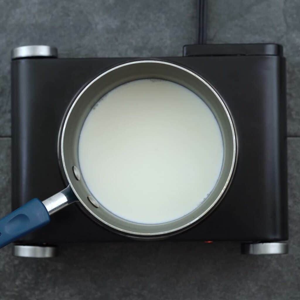 Heating milk in saucepan.
