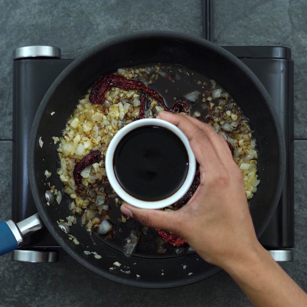 Adding the sauces to the stir fried mixture