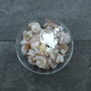 Cornstarch and other seasoning added to shrimp