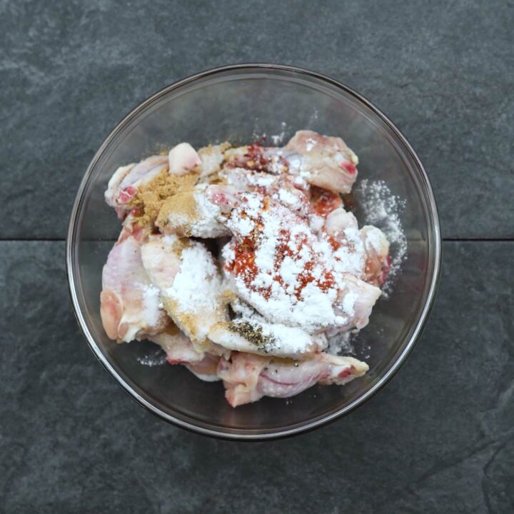 Chicken wings with seasoning powders in a bowl