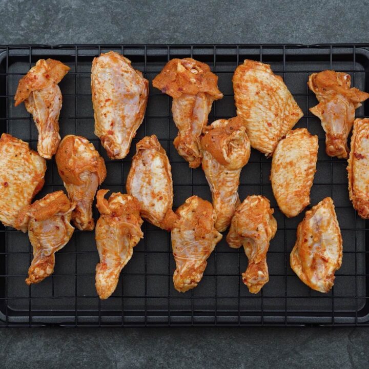 Marinated wings arranged on a wire rack