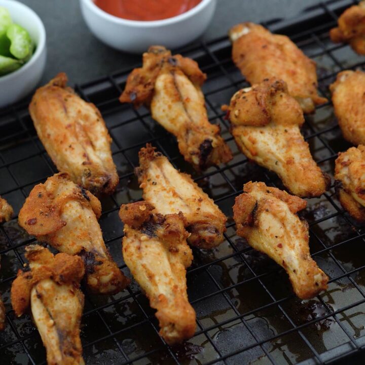 Baked Chicken wings served with sauce and celery sticks
