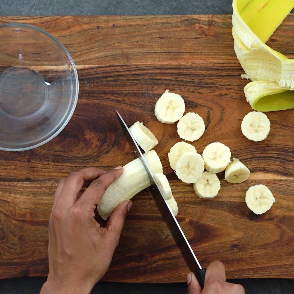 Chopping the banana with knife.