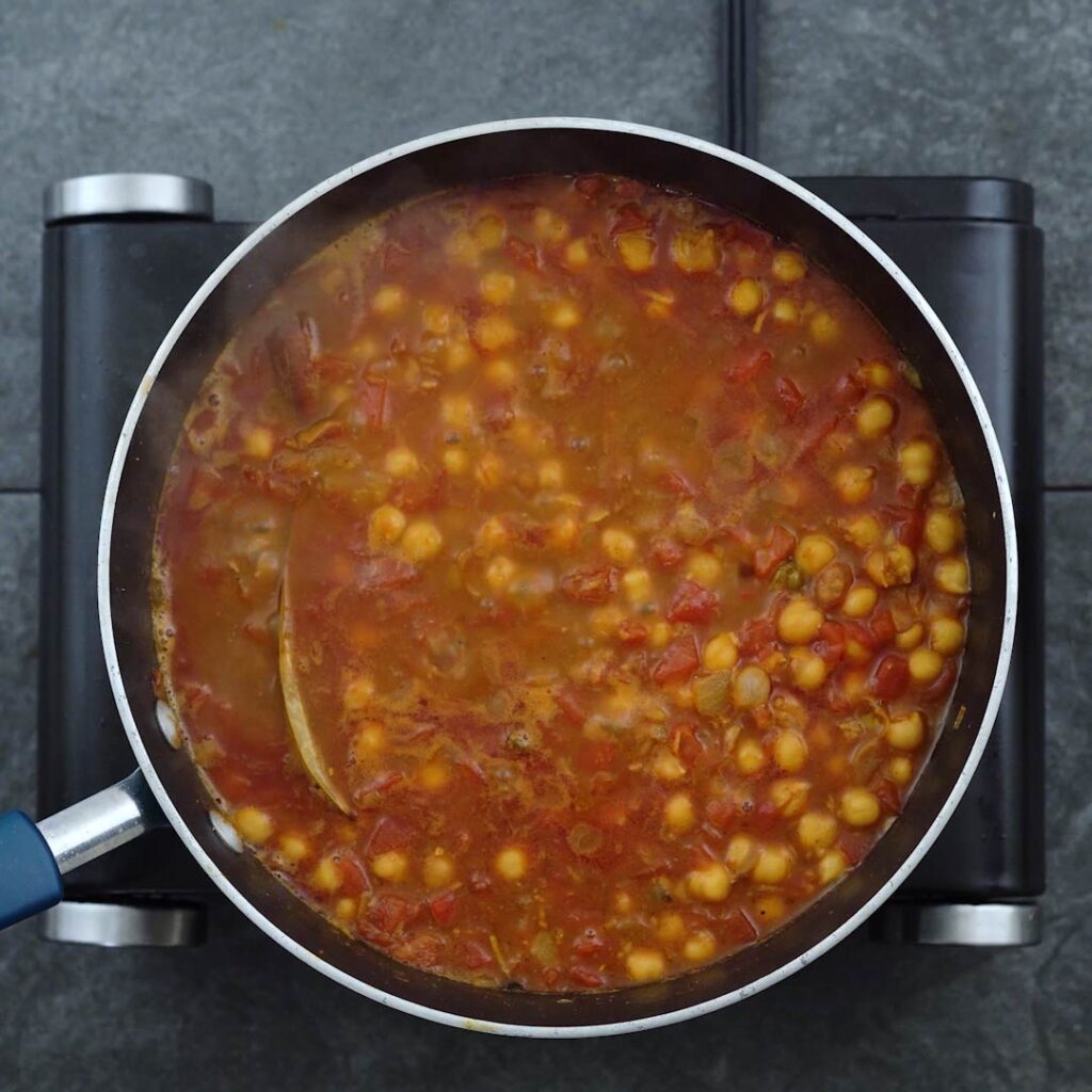 Punjabi Chole is cooking in a pan