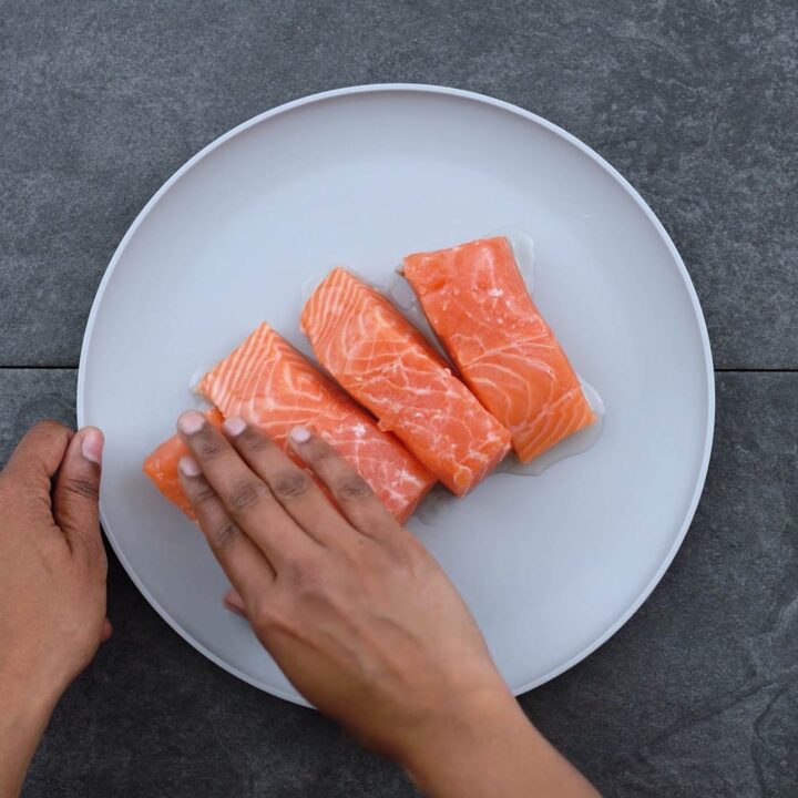 Rubbing salmon with oil