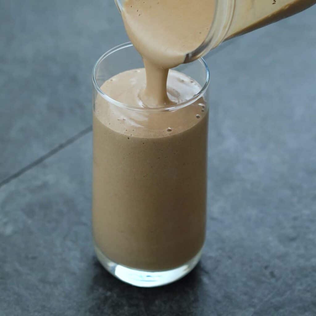 Pouring Protein Smoothie into a serving glass.