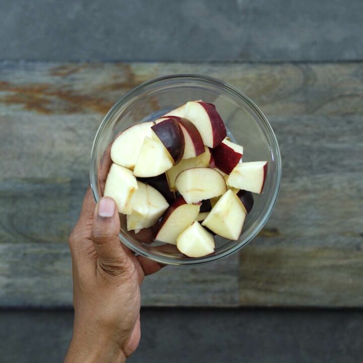 Chopped red apples in a bowl.