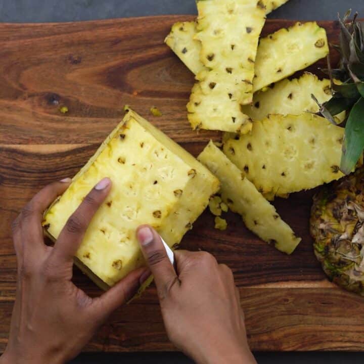 Cleaning the eyes of the pineapple.