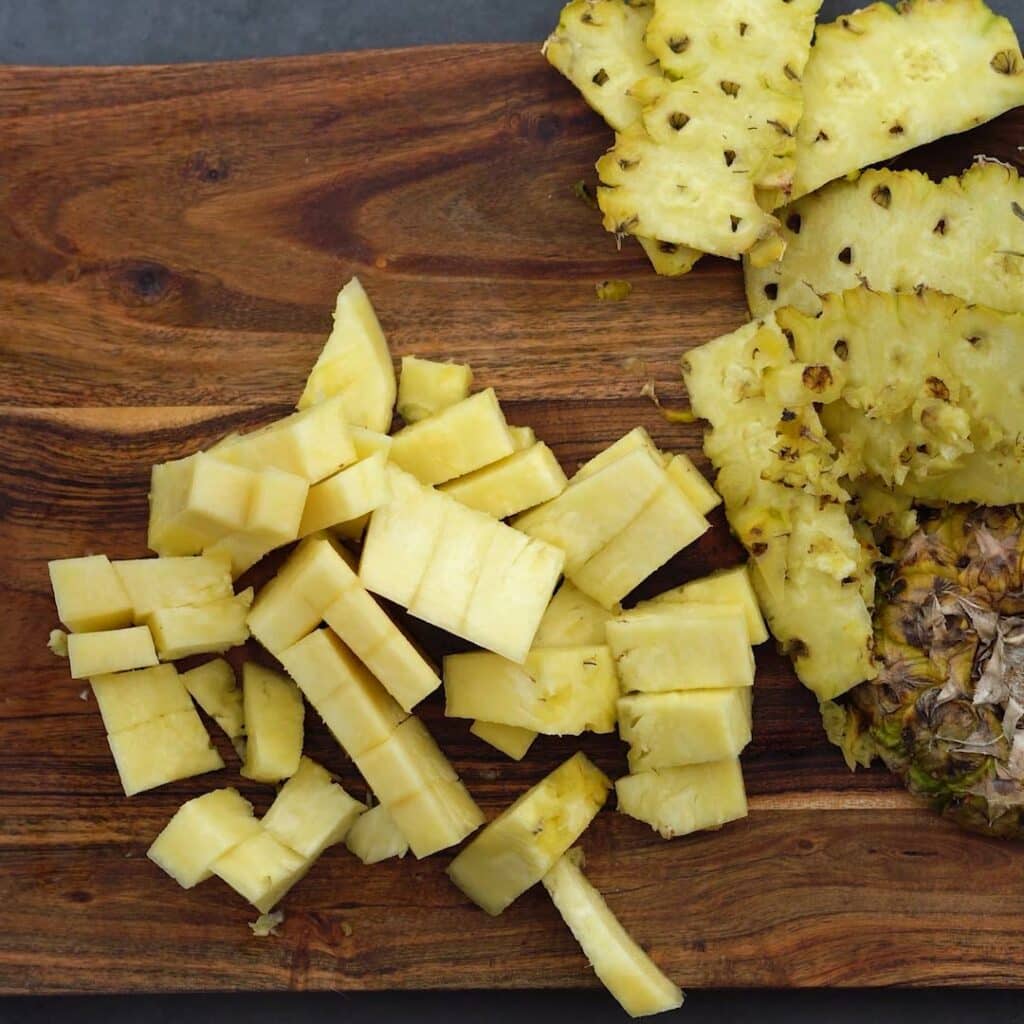 Chopped pineapple in a board.