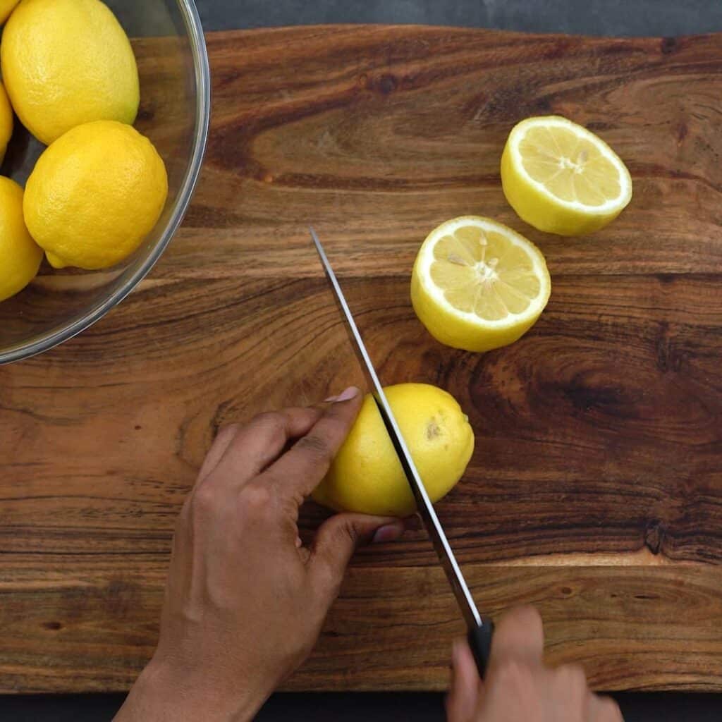 Cutting the lemon in half.