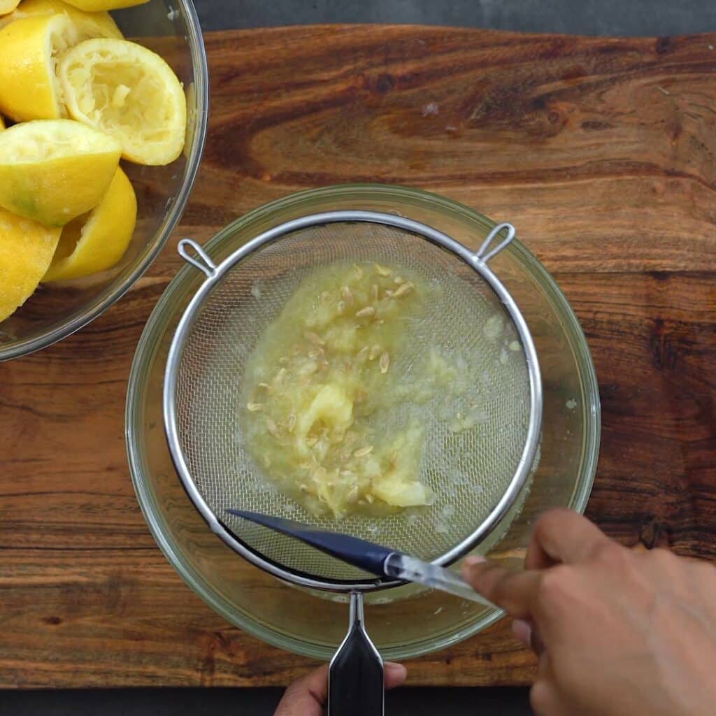 Extracting the juice from pulp in strainer.