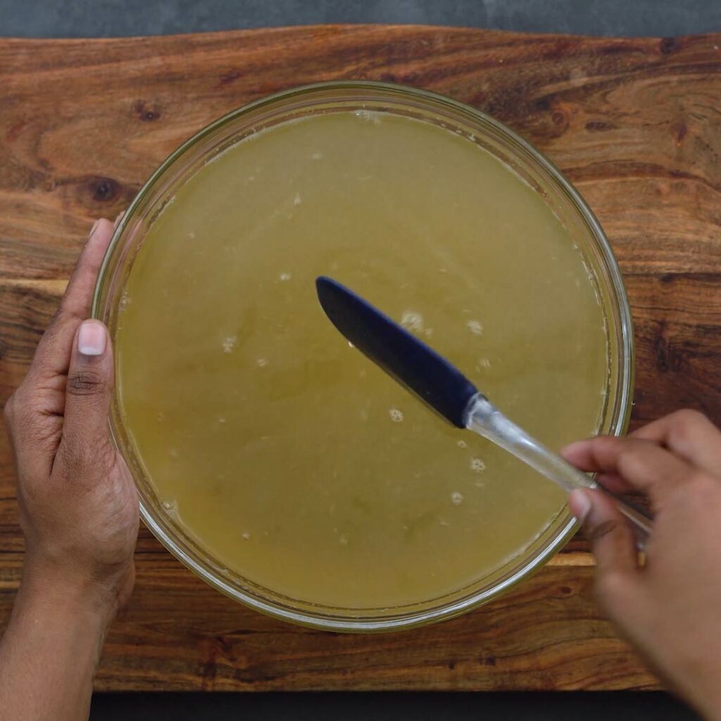 Mixing the lemonade in a bowl with spatula.