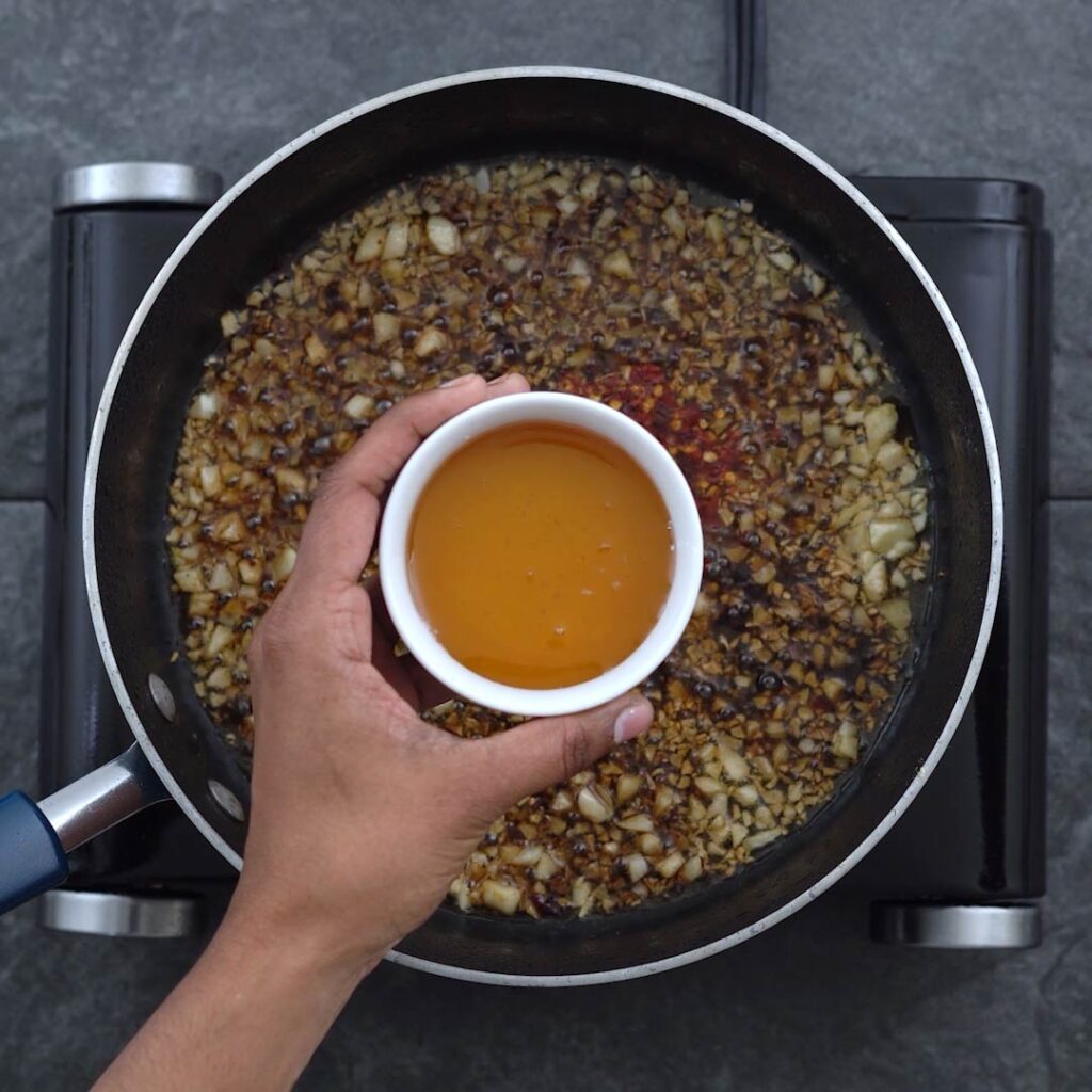 Adding honey to garlic and soy sauce mixture
