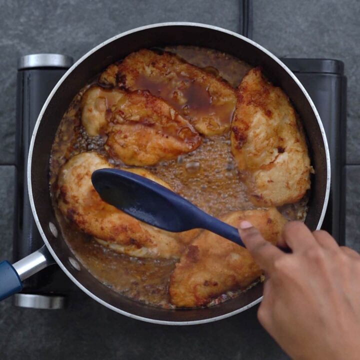 Coating chicken breast with honey garlic sauce