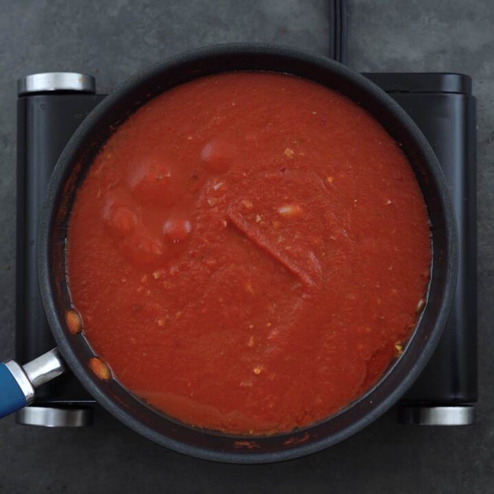 Tomato sauce simmering in a pan