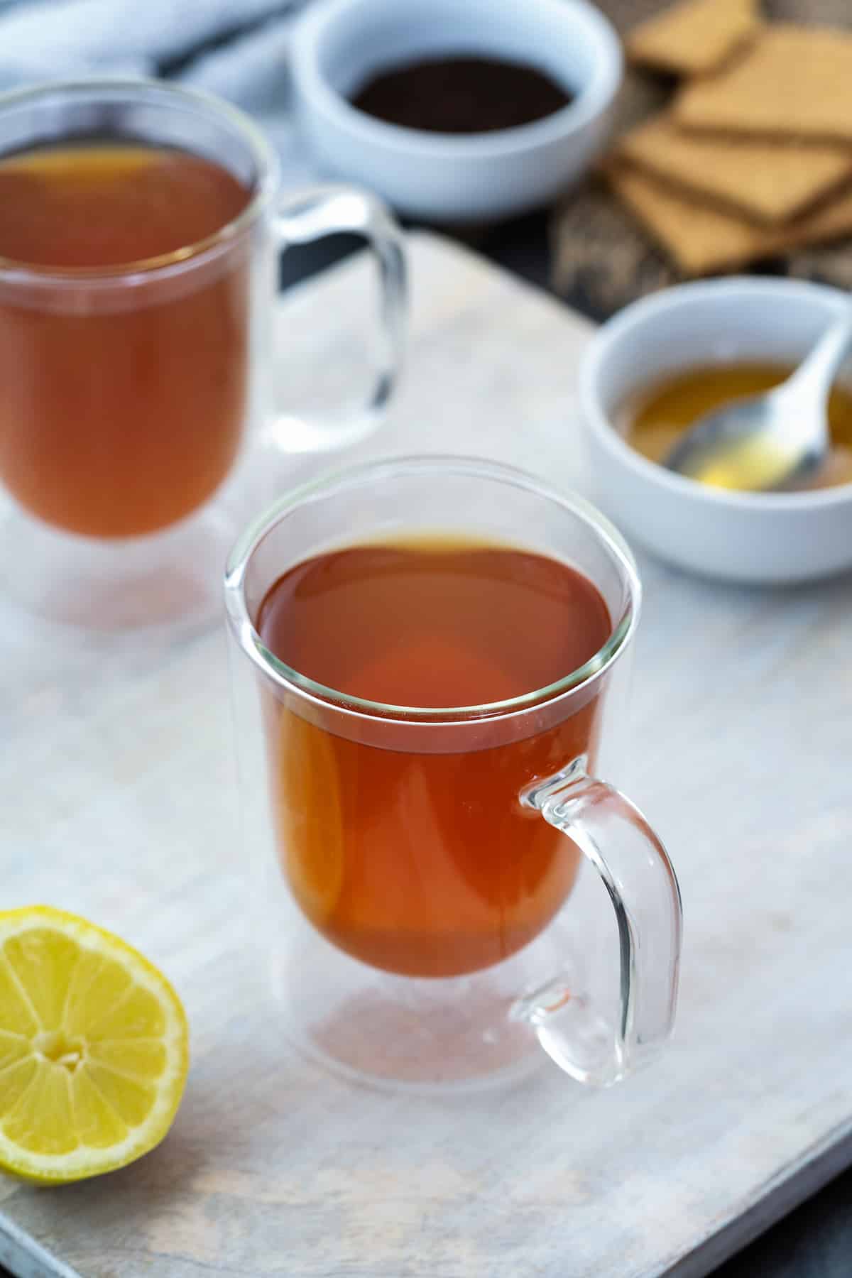 Honey and Lemon Tea in a cup placed on a white table.