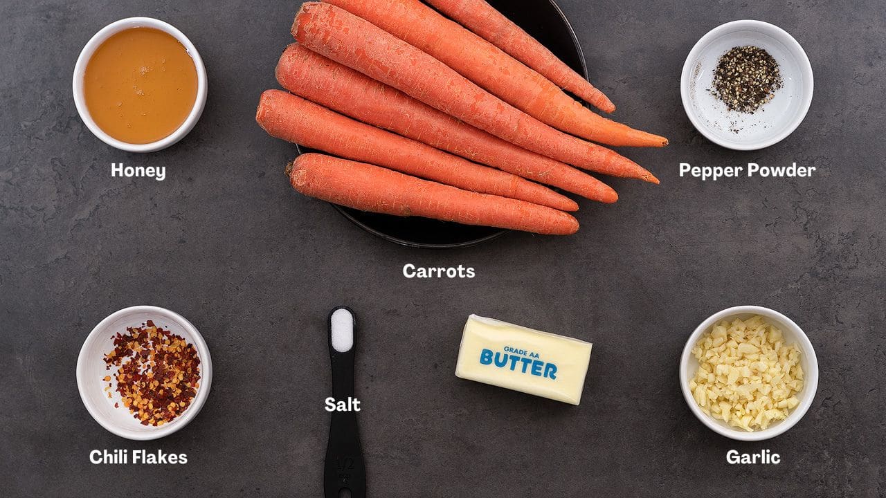 Honey Glazed Carrots recipe Ingredients placed on a gray table