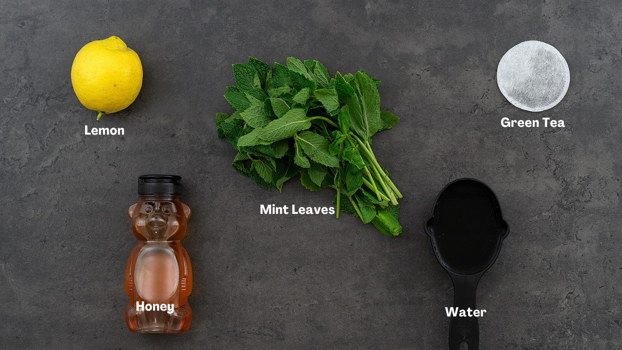 Mint tea recipe ingredients place on a grey table.