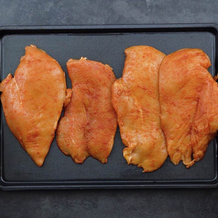 Seasoned Chicken Breasts on a baking tray