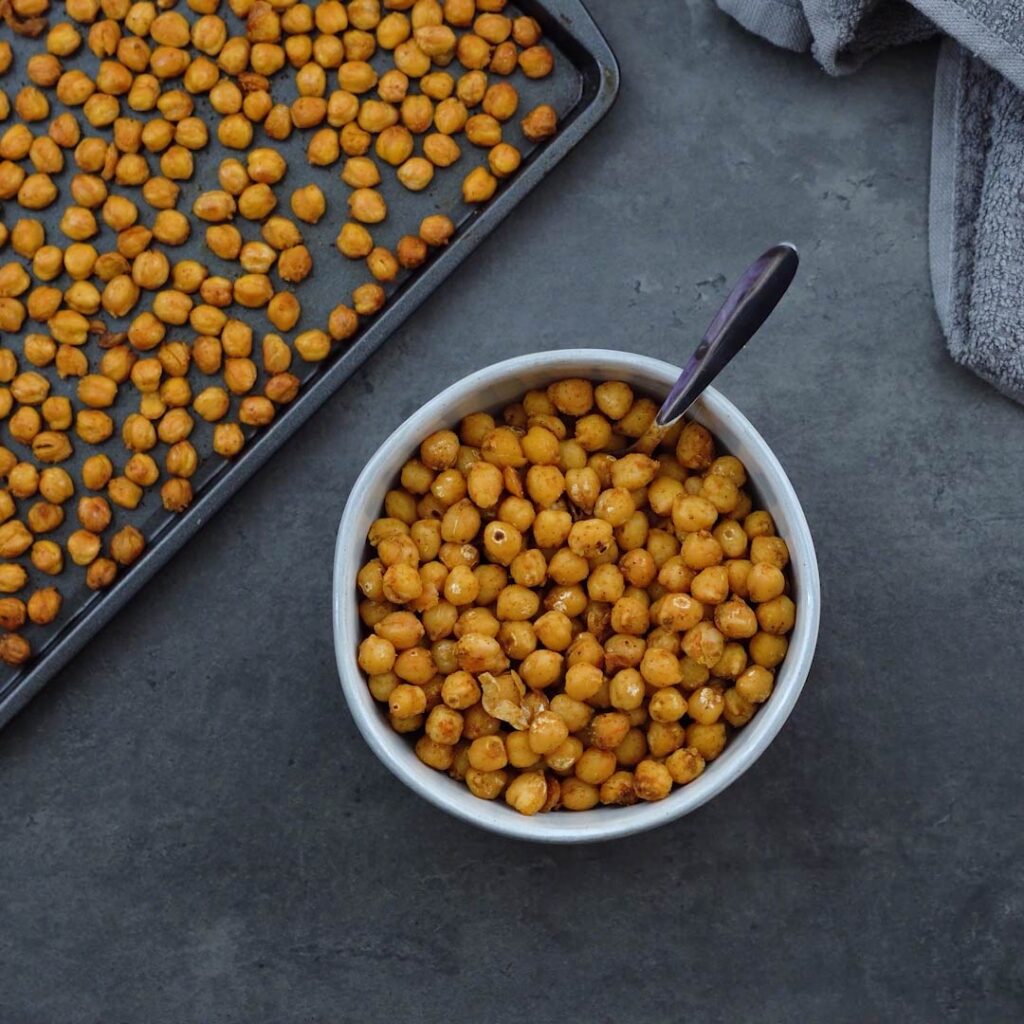Oven Roasted Chickpeas and Pan Roasted Chickpeas served in a tray and bowl